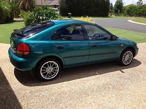Ford Laser LXi (1998) 5D Hatchback 4 SP Automatic (1.6L - Multi Point F/INJ)